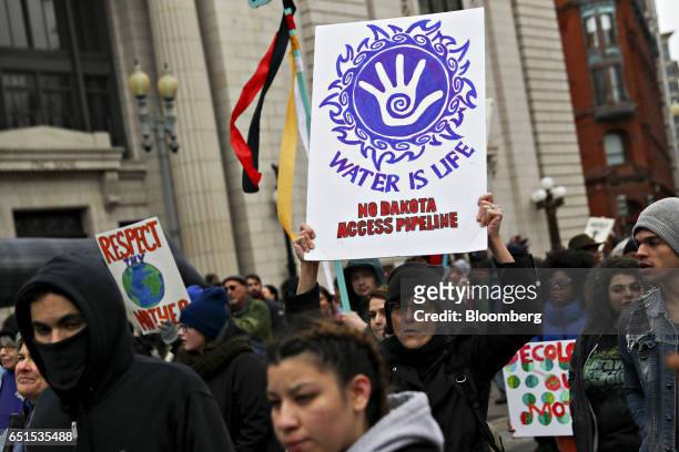 Demonstrator carries a "Water Is Life" sign during a protest against the Dakota Access Pipeline in Washington, D.C., U.S., on Friday, March 10, 2017....