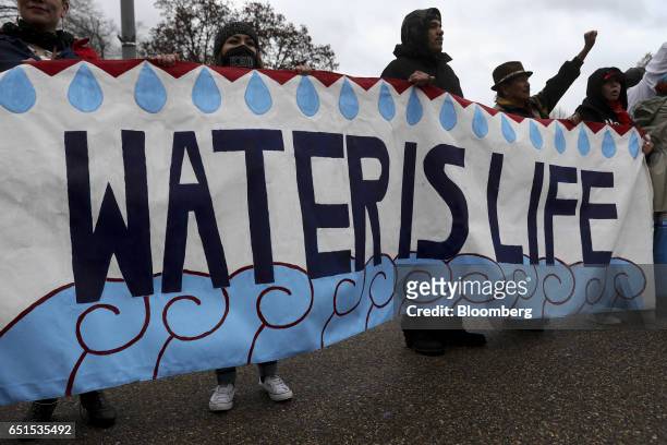 Demonstrators hold a "Water Is Life" sign during a protest against the Dakota Access Pipeline in Washington, D.C., U.S., on Friday, March 10, 2017....