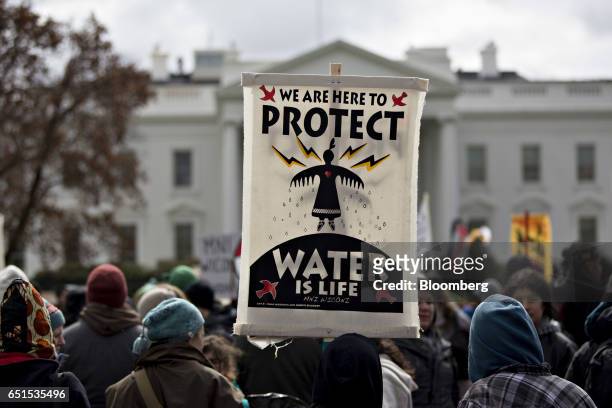 Demonstrator holds a "Water Is Life" sign in front of the White House during a protest against the Dakota Access Pipeline in Washington, D.C., U.S.,...