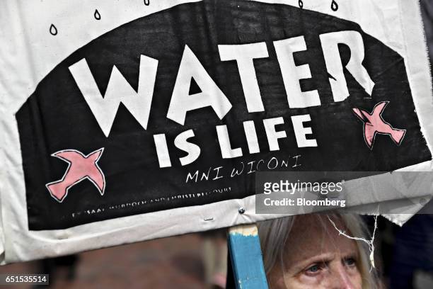 Demonstrator holds a "Water Is Life" sign during a protest against the Dakota Access Pipeline in Washington, D.C., U.S., on Friday, March 10, 2017....