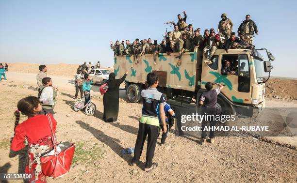Sunni fighters, newly recruited into the Hashed al-Shaabi paramilitaries, advance to protect the west Mosul district of Tel Rumman, during the...