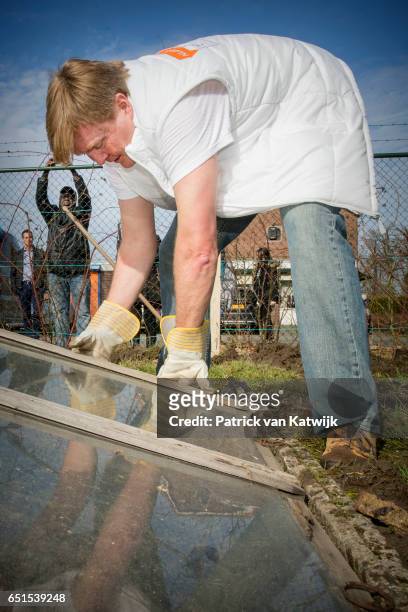 King Willem-Alexander of the Netherlands volunteering for NL Doet in the neighborhood garden on March 08, 2017 in Breda, Netherlands. NL Doet is a...