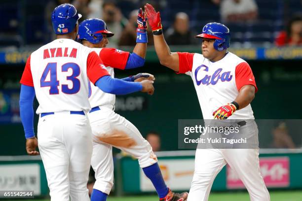 Alfredo Despaigne of Team Cuba is greeted at home plate after hitting a gland slam in the fifth inning during Game 5 of Pool B of the 2017 World...