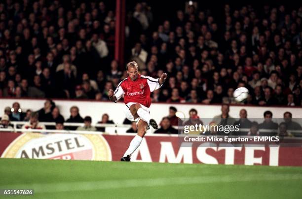 Arsenal's Dennis Bergkamp fires in a free kick