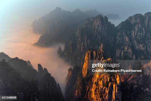 aerial view of huangshan mountain with fog scene - huangshan stock-fotos und bilder