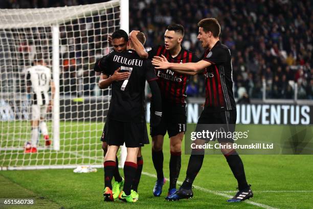 Carlos Bacca of AC Milan celebrates scoring his team's first goal to make the score 1-1 with his team-mates during the Serie A match between Juventus...