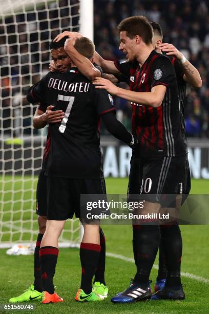 Carlos Bacca of AC Milan celebrates scoring his team's first goal to make the score 1-1 with his team-mates during the Serie A match between Juventus...