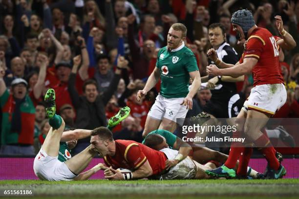 George North of Wales beats the Ireland defence as he scores their first try during the Six Nations match between Wales and Ireland at the...