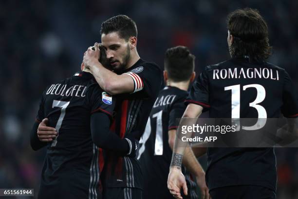 Milan's defender Mattia De Sciglio and AC Milan's midfielder Gerard Deulofeu from France celebrate a goal during the Italian Serie A football match...