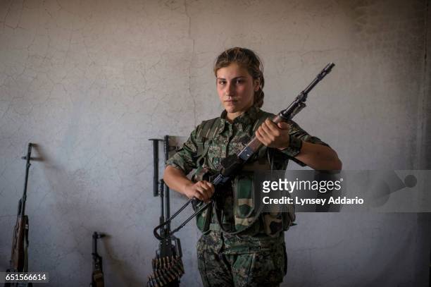 Xwinda a YPG fighter in training, poses for a portrait with her gun at a base in the former ISIS and Jabat al Nusra stronghold of Tel Bark, which was...