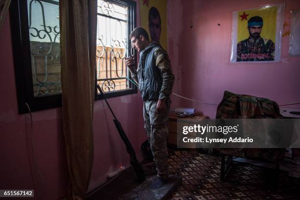 Fighter talks on a radio at a base at the former ISIS and Jabat al Nusra stronghold of Tel Bark, which was taken over by YPG fighters less than a...