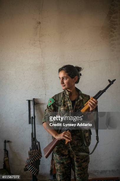 Fighter in training, Nuda from Qamishlo, poses for a portrait at a base in the former ISIS and Jabat al Nusra stronghold of Tel Bark, which was taken...