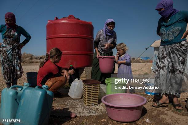 Yazidi refugees displaced roughly one year prior when fighters with the Islamic State attacked their villages around Sinjar Mountains live in the...