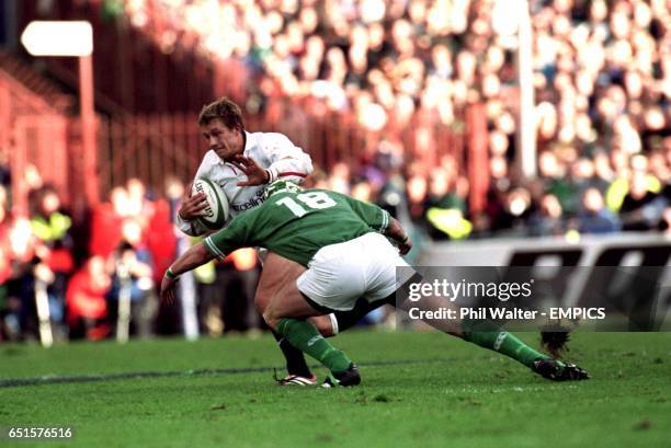 England's Jonny Wilkinson fends off Ireland's Trevor Brennan.