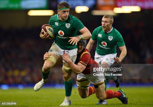 Jamie Heaslip of Ireland is tackled by Jonathan Davies of Wales during the Six Nations match between Wales and Ireland at the Principality Stadium on...