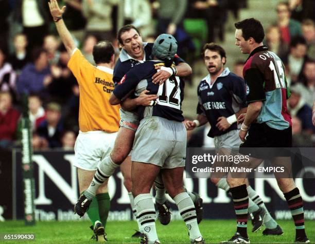 Castres' Eric Artiguste leaps on tryscorer Norm Berryman as Harlequins Ryan O'Neill looks on dejected