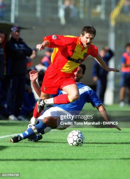 Brescia's Federico Giunti slides in on Lecce's Davor Vugrinec