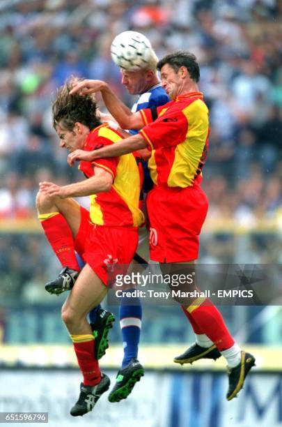 Brescia's Igli Tare is outnumbered as he goes for a header with Lecce's Lorenzo Stovini and Gheorghe Popescu