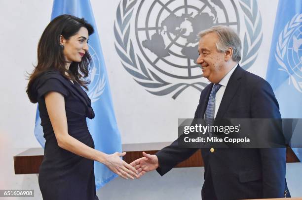 Amal Clooney and 9th Secretary-General of the United Nations António Guterres shake hands at United Nations Headquarters on March 10, 2017 in New...