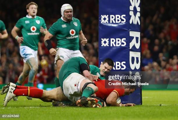 Jamie Roberts of Wales beats the Ireland defence as he scores their third try with George North during the Six Nations match between Wales and...