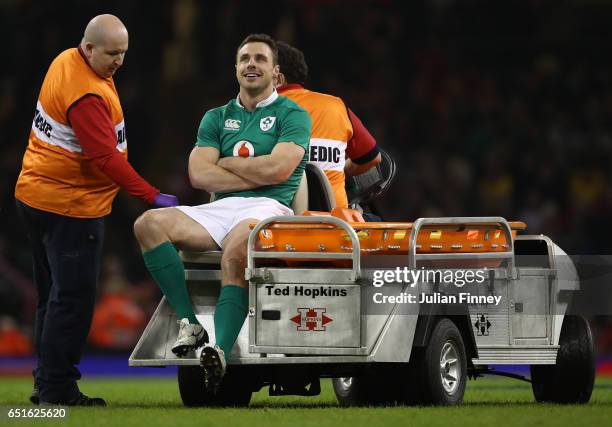 An injured Tommy Bowe of Ireland is carted off during the Six Nations match between Wales and Ireland at the Principality Stadium on March 10, 2017...