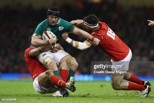 Sean O'Brien of Ireland is tackled by Jamie Roberts and Scott Baldwin of Wales during the Six Nations match between Wales and Ireland at the...
