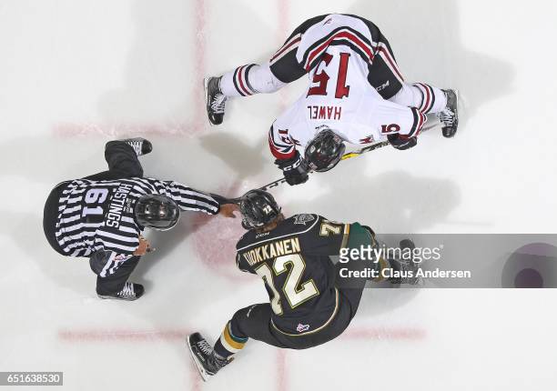 Liam Hawel of the Guelph Storm takes a faceoff against Janne Kuokkanen of the London Knights during an OHL game at Budweiser Gardens on March 9, 2017...