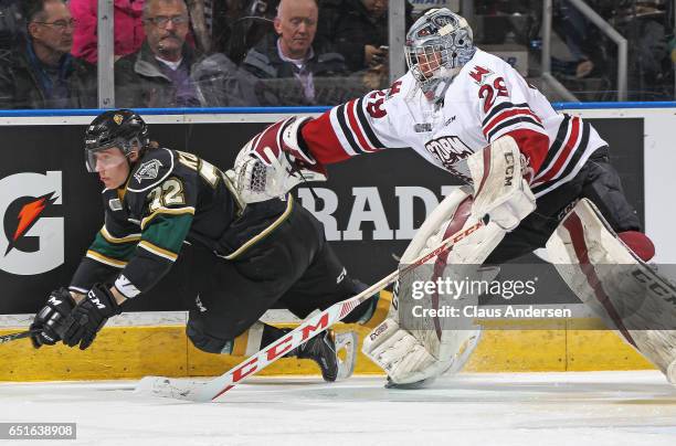 Liam Herbst of the Guelph Storm trips up Janne Kuokkanen of the London Knights during an OHL game at Budweiser Gardens on March 9, 2017 in London,...