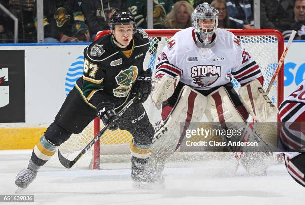 Mitchell Stephens of the London Knights looks for a puck to tip against Liam Herbst of the Guelph Storm during an OHL game at Budweiser Gardens on...