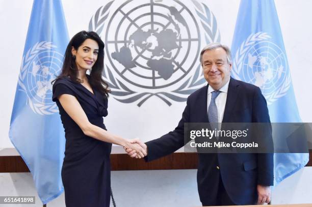 International Human Rights Lawyer Amal Clooney and 9th Secretary-General of the United Nations António Guterres shake hands at United Nations...