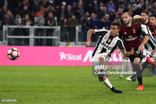 Paulo Dybala of Juventus FC scores a penalty in injury time to make the score 2-1 during the Serie A match between Juventus FC and AC Milan at...