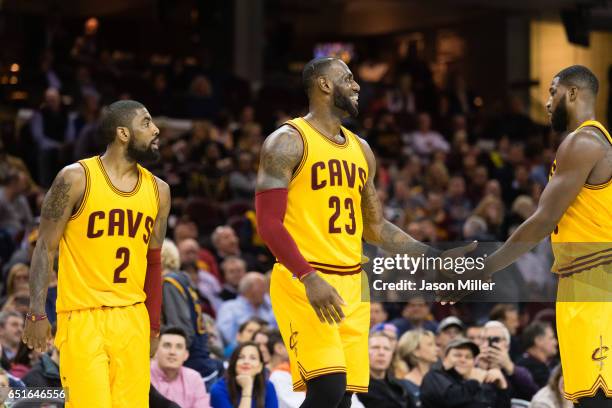 Kyrie Irving LeBron James and Tristan Thompson of the Cleveland Cavaliers celebrate after a play during the second half against the Milwaukee Bucks...