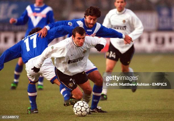 Inter Milan's Okan Buruk escapes being sandwiched by Brescia defenders