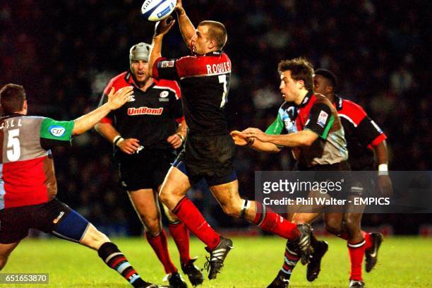 Saracens' Tony Roques grabs the ball in the air between NEC Harlequins' Ryan O'Neill and Dan Luger