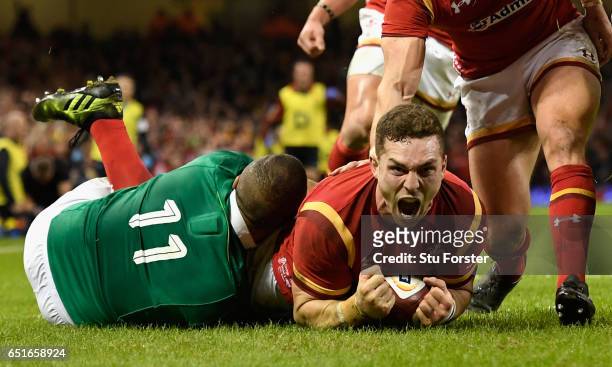 George North of Wales celebrates after scoring their first try during the Six Nations match between Wales and Ireland at the Principality Stadium on...