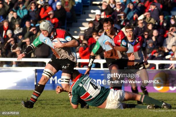 Harlequins's Alex Codling steps over Leicester Tigers's Martin Johnson.