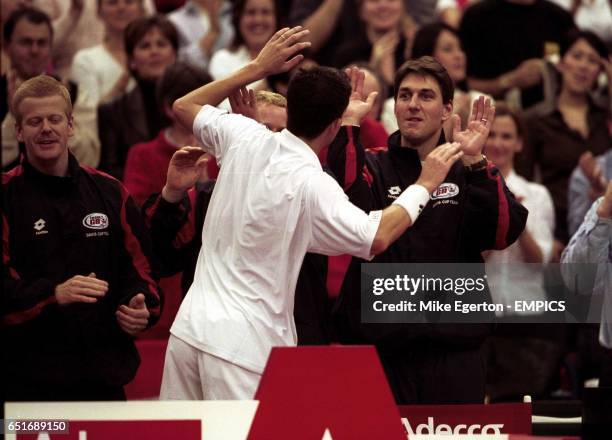 Great Britain's Tim Henman celebrates victory with his teammates