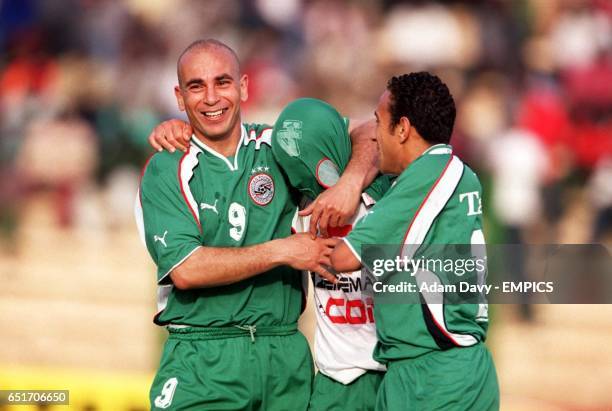 Egypt's Hossam Hassan and Tarek Said congratulate goalscorer Hazem Emam