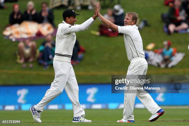 Jeet Raval and Neil Wagner of New Zealand celebrate the dismissal of Hashim Amla during day four of the First Test match between New Zealand and...