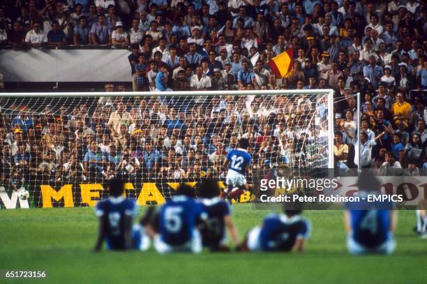 The France team watch from the centre circle as teammate Alain Giresse converts his penalty, sending West Germany goalkeeper Harald Schumacher the...