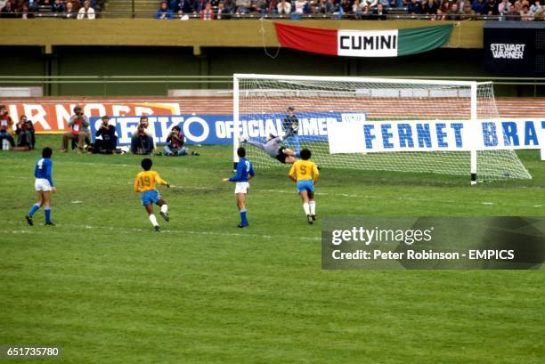 Brazil's Mendonca and Reinaldo look on as Italy goalkeeper Dino Zoff is beaten by a 35 yard drive from Brazil's Nelinho