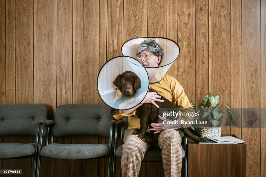 Man at Veterinarian Wearing Dog Cone