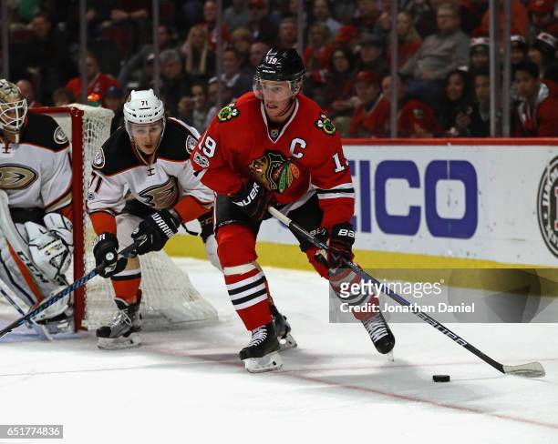 Jonathan Toews of the Chicago Blackhawks looks to pass under pressure from Brandon Montour of the Anaheim Ducks at the United Center on March 9, 2017...