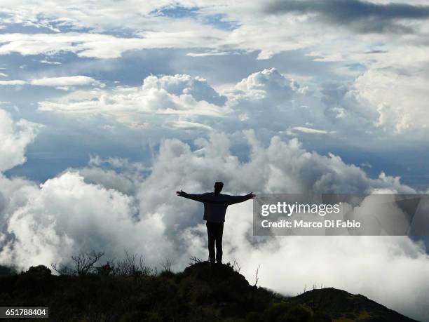 man in the clouds - mount meru stock pictures, royalty-free photos & images
