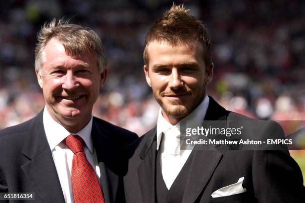 Manchester United's David Beckham with manager Sir Alex Ferguson after signing a new contract