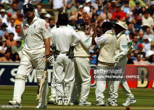 England's Andrew Flintoff leaves the pitch after being caught by Sri Lanka's Hashan Tillakaratne off the bowling of Muttiah Muralitharan