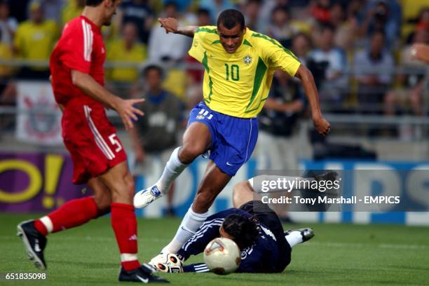 Turkey's goalkeeper Recber Rustu dives at the feet of Brazil's Rivaldo