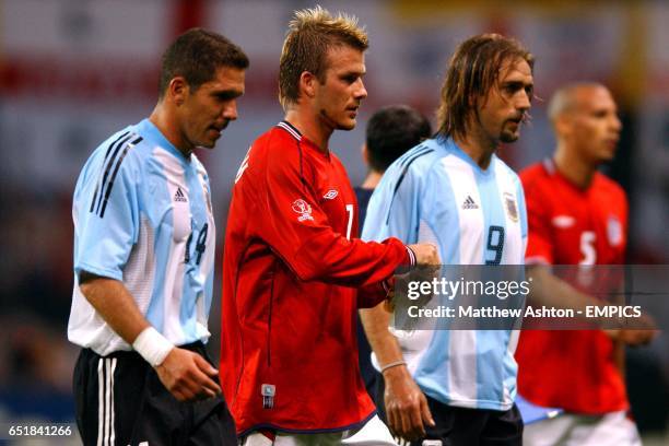 Having just given his side the lead England's David Beckham walks off at half-time alongside Argentina's Diego Simeone and Gabriel Batistuta