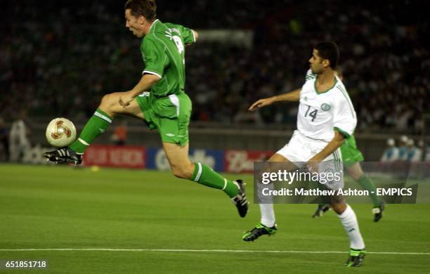 Ireland's Matt Holland takes the ball away from Saudi's Abdulaziz Khathran