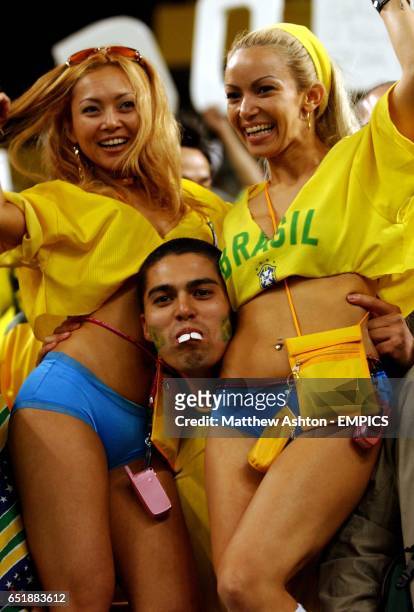 Brazilian Ronaldo fan celebrates reaching the World Cup Final with two fans